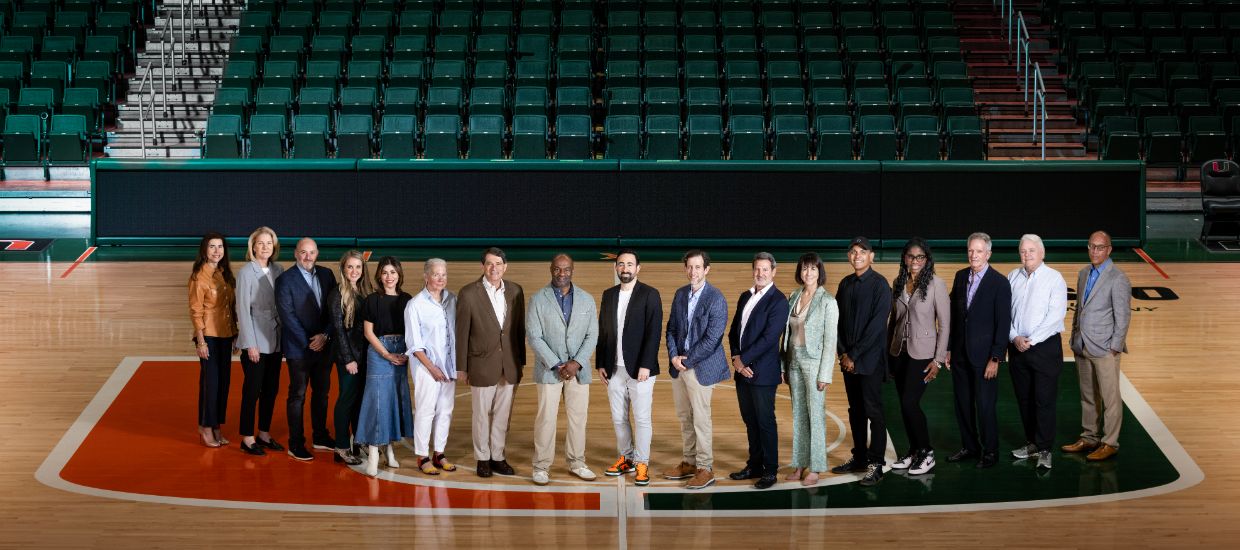 faculty standing at a basketball court