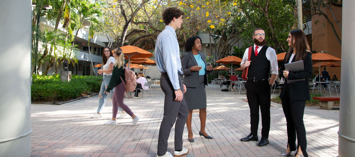 professor talking with students outside